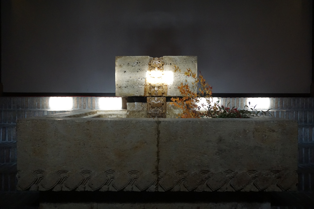 欄間窓から入る太陽光が、泉水の日華石中央に彫られた打出の小槌を照射する様子
